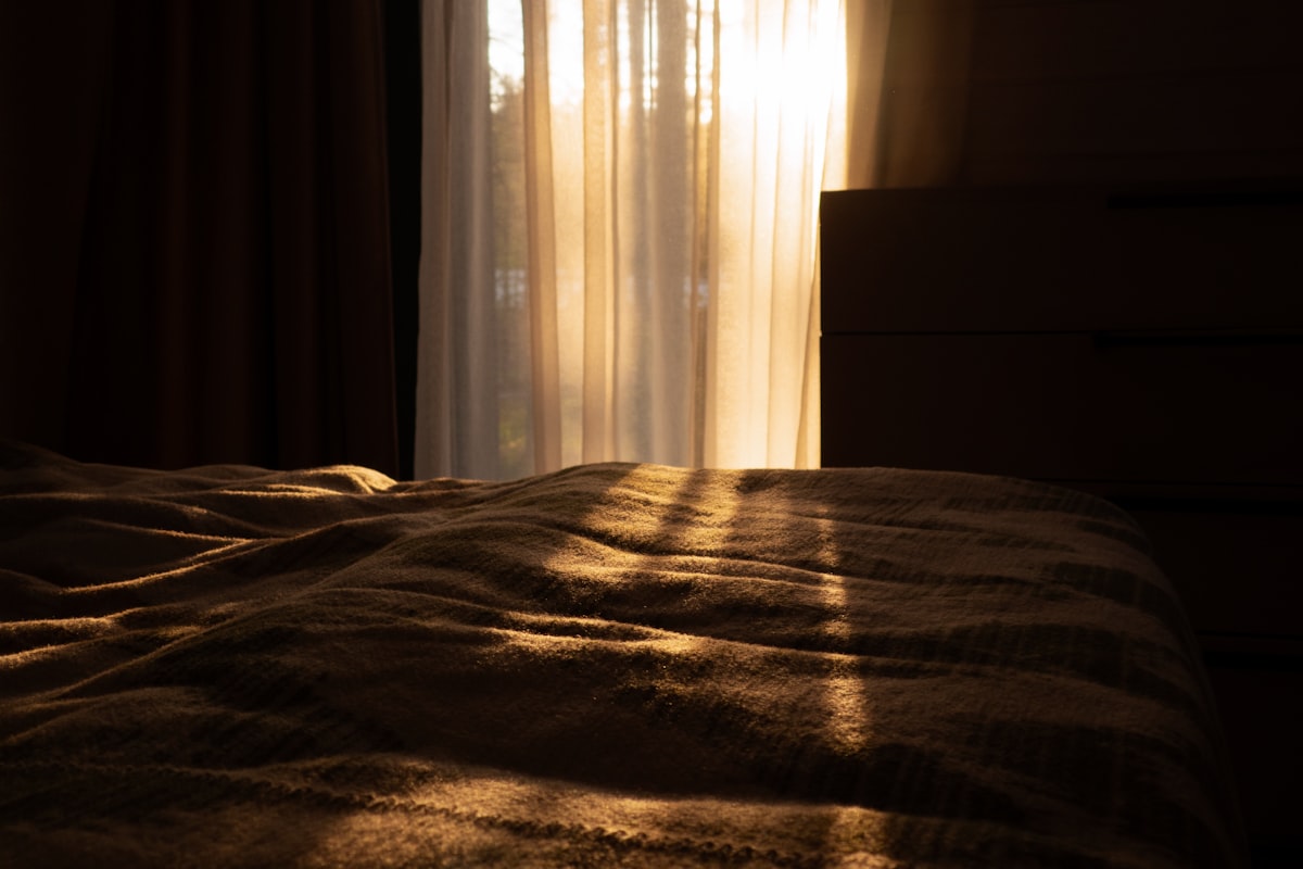 Golden evening light glowing through sheer curtains